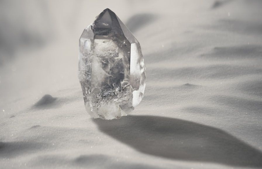 Large Quartz Crystal On A Snowy Background Close-up.